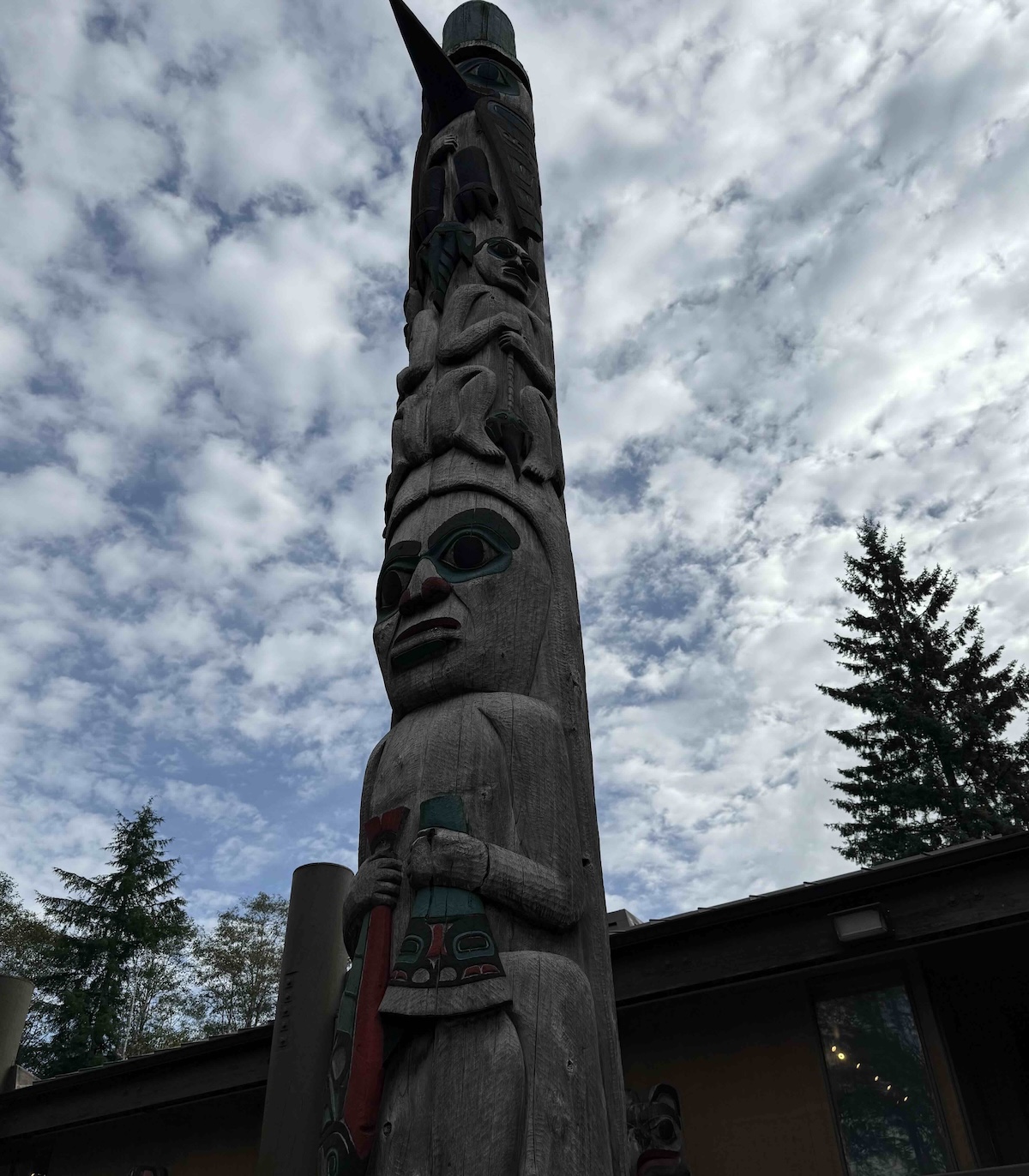 A totem pole with a person holding a sword
AI-generated content may be incorrect.